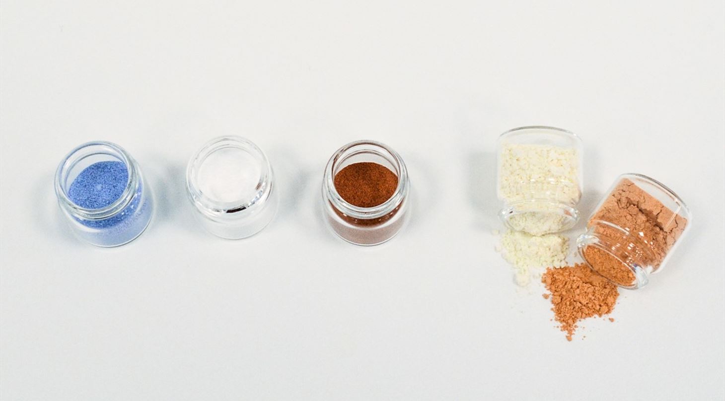 coloured powders in glass vials